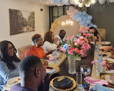 Guests seated at a styled pink dinner table