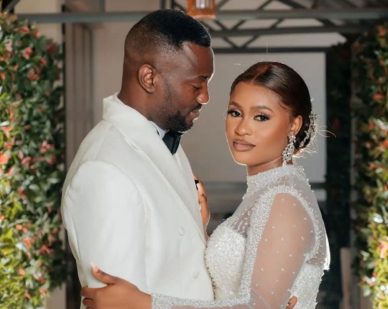Couple embracing in white outfits